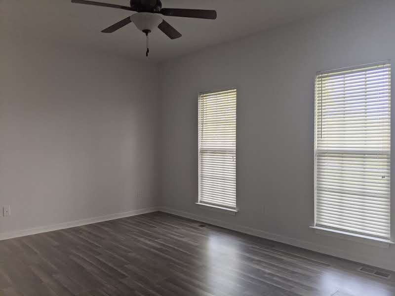 812 Blakemore Road Dickson, TN 37055 - Photo 17 of 25 an empty room with wooden floor fan and windows