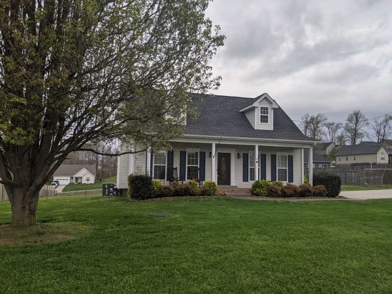 812 Blakemore Road Dickson, TN 37055 - Photo 4 of 25 a front view of a house with garden and trees