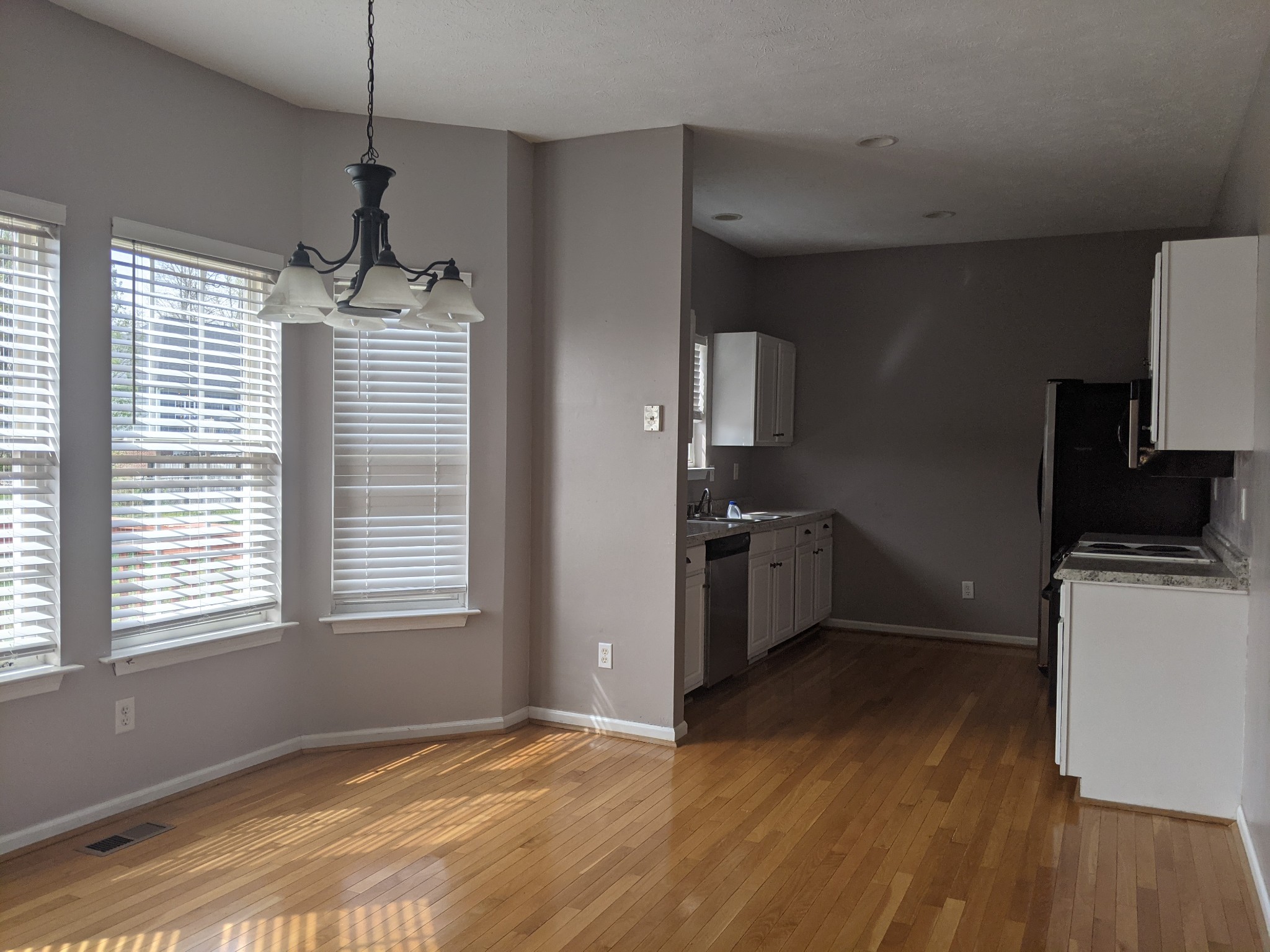 812 Blakemore Road Dickson, TN 37055 - Photo 9 of 25 a kitchen with kitchen island a sink wooden floor and a window