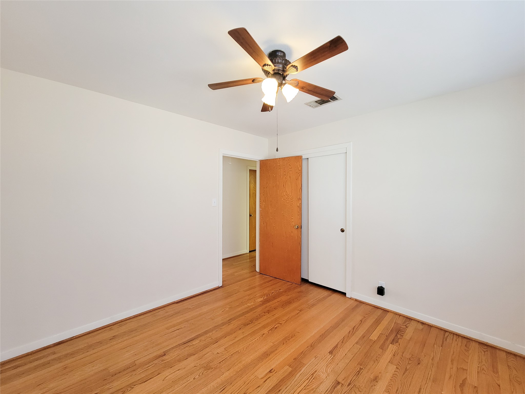 5442 Kinglet Street Houston, TX 77096 - Photo 13 of 25 a view of an empty room with wooden floor