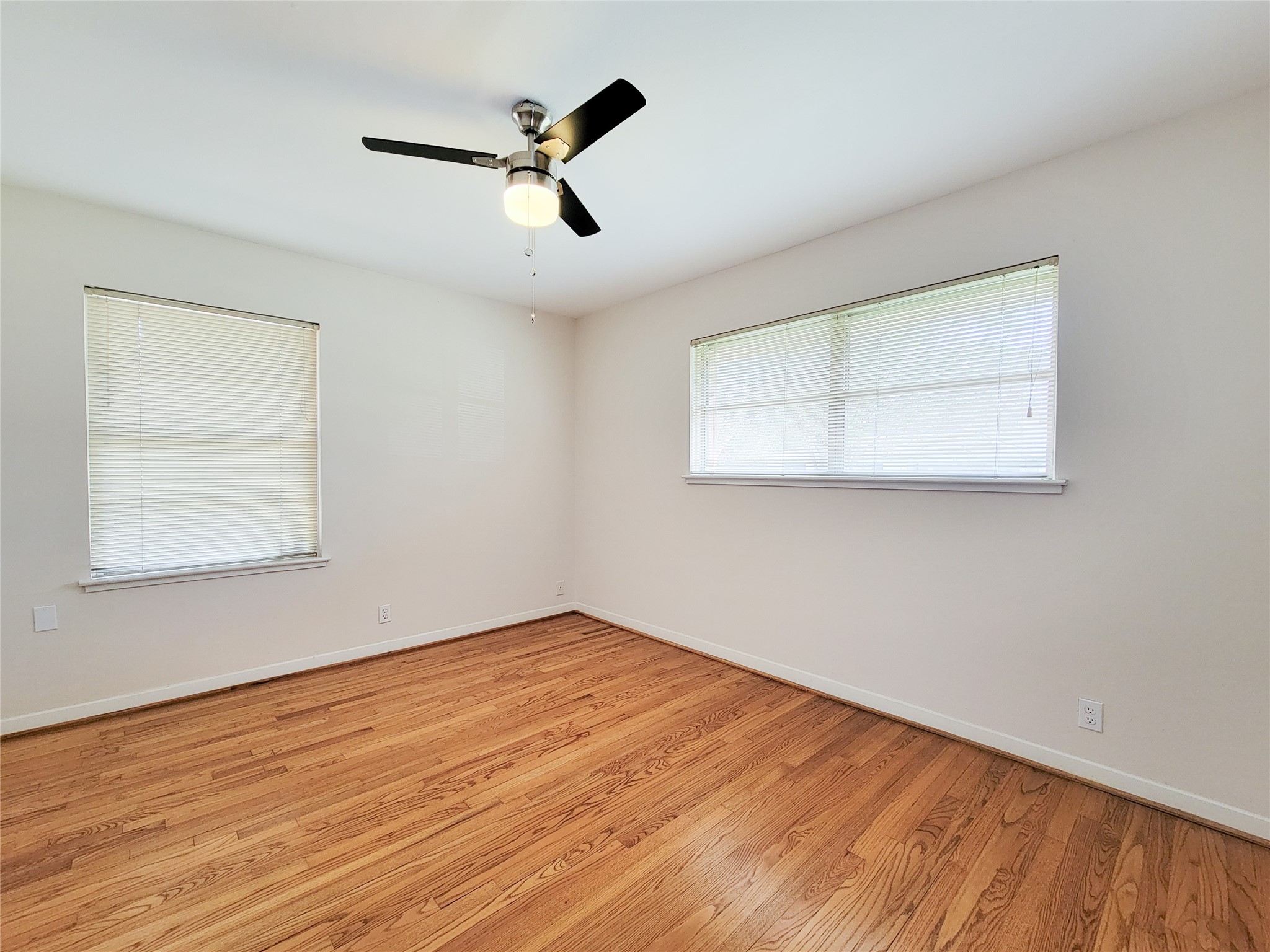 5442 Kinglet Street Houston, TX 77096 - Photo 14 of 25 wooden floor in an empty room with a window