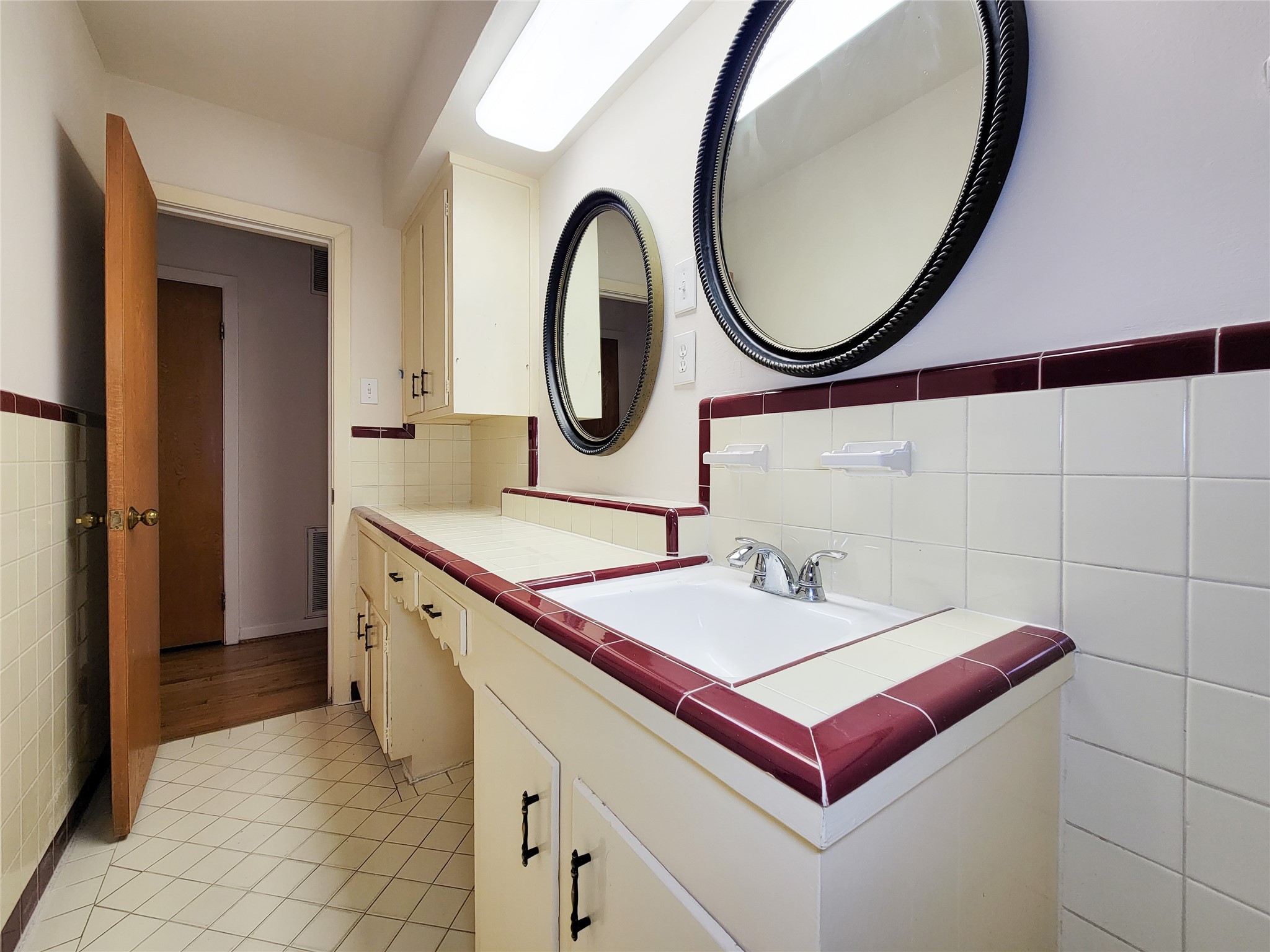 5442 Kinglet Street Houston, TX 77096 - Photo 18 of 25 a bathroom with a sink and a mirror
