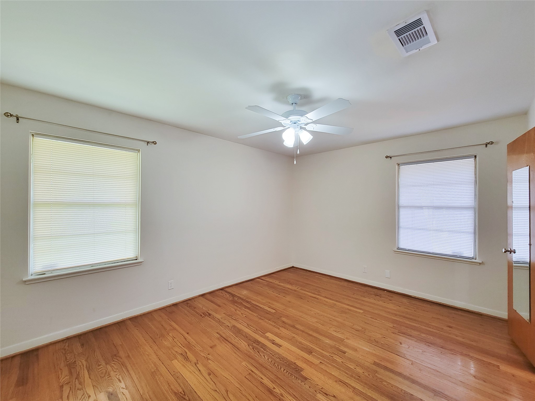 5442 Kinglet Street Houston, TX 77096 - Photo 9 of 25 a view of an empty room with a window and wooden floor