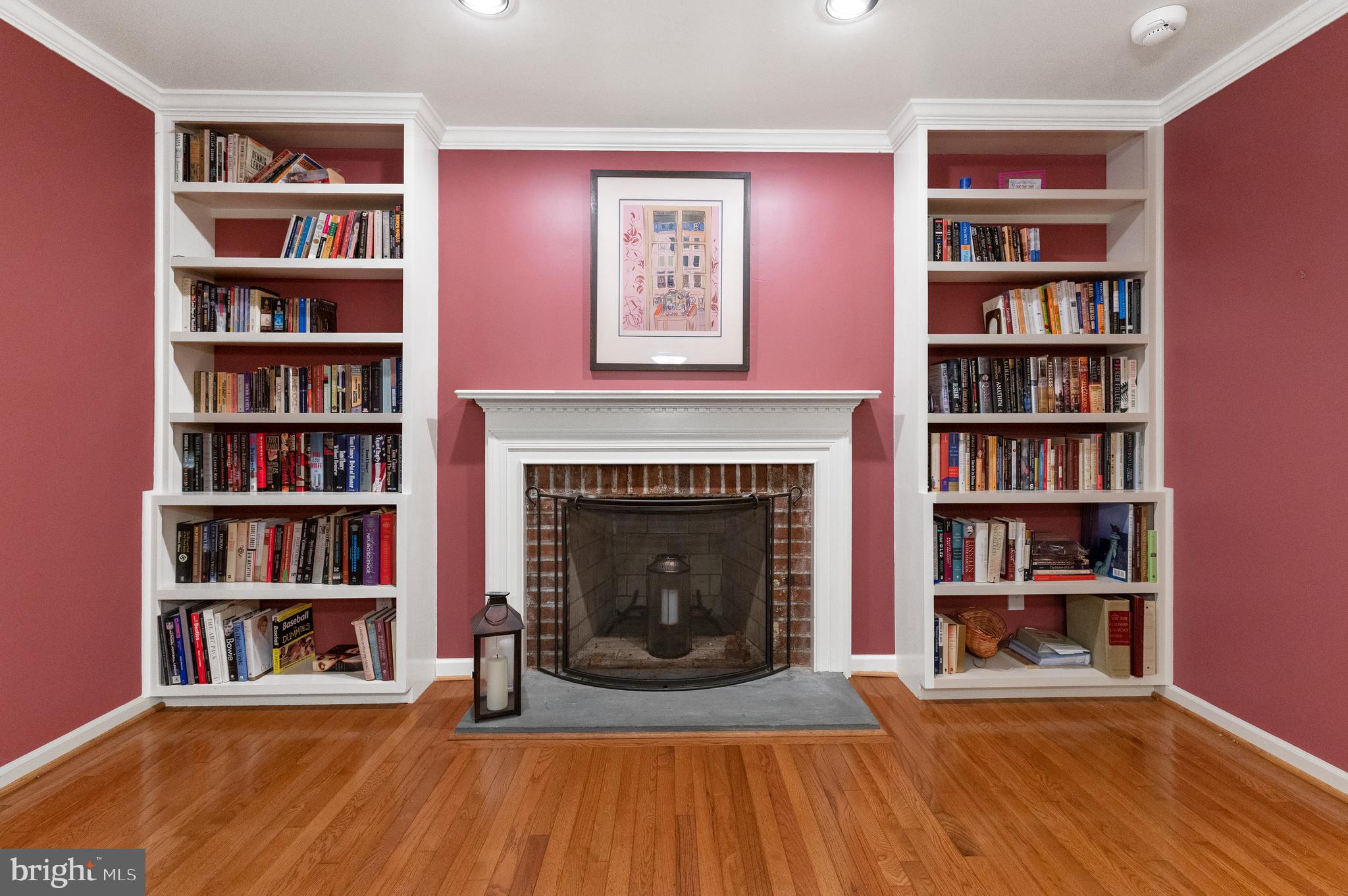 850 Hollow Road Wayne, PA 19087 - Photo 7 of 37 a living room with a book shelf and a fireplace