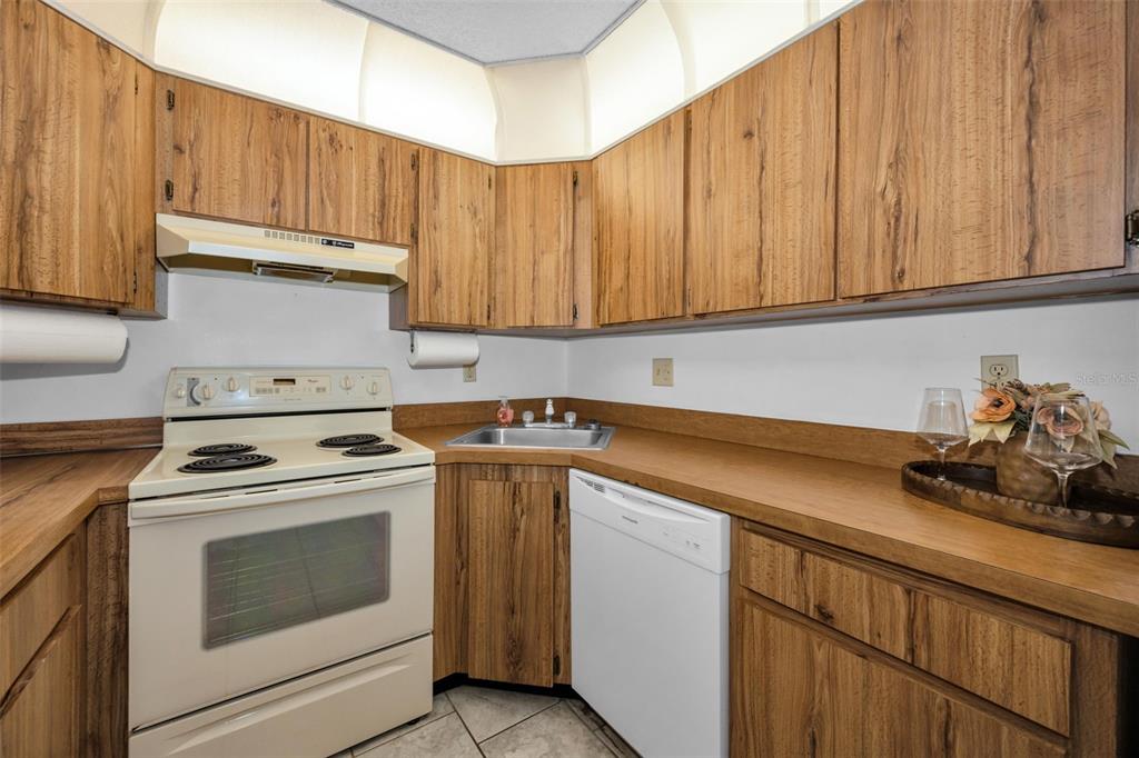2687 Pine Ridge Way South, Unit B2 Palm Harbor, FL 34684 - Photo 14 of 68 a kitchen with a stove and a sink