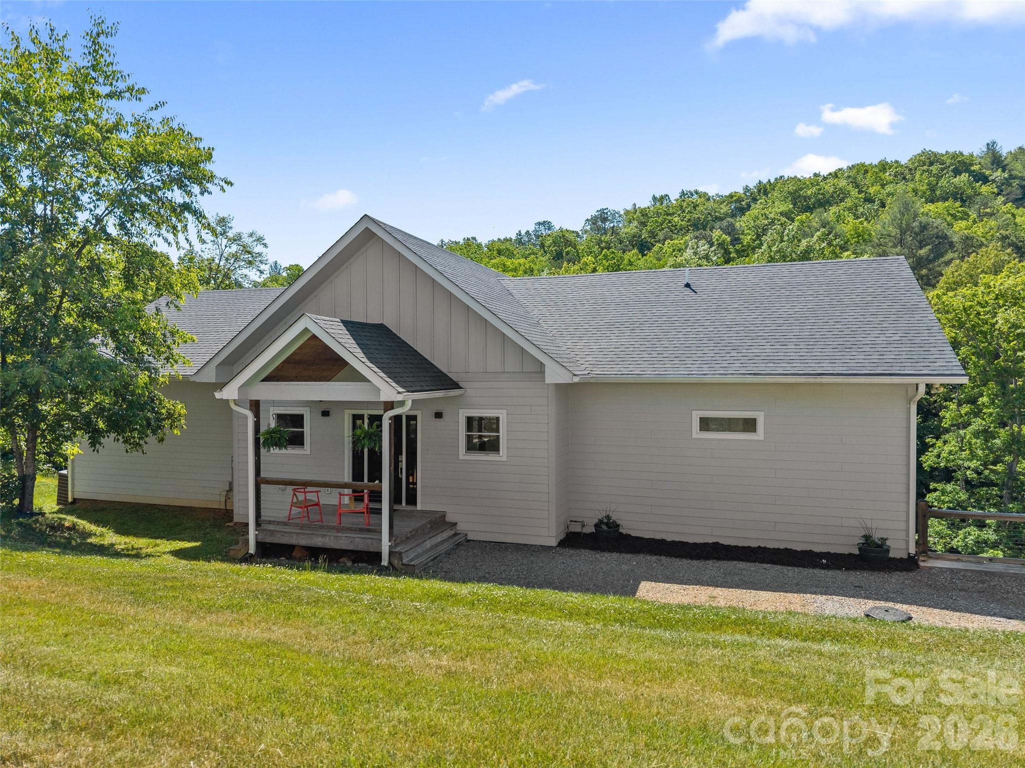 123 Israel Road Candler, NC 28715 - Photo 4 of 44 a house view with a garden space