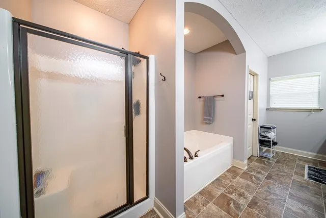 a bathroom with a tub and shower