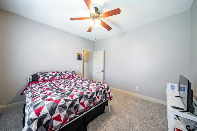 a bedroom with a bed and a tv