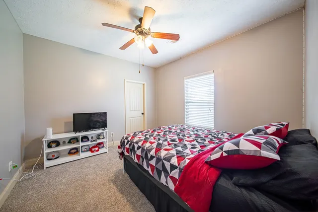 a bedroom with a bed and a flat screen tv