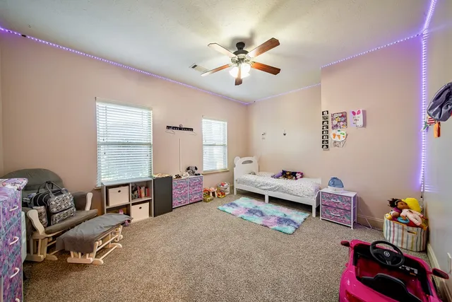 a bedroom with furniture and a window