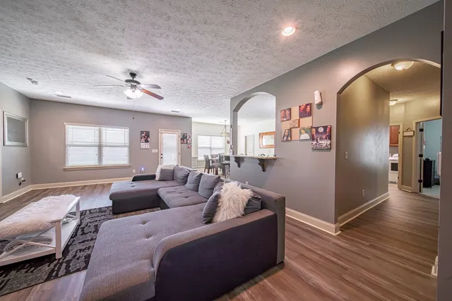 a living room with furniture and a chandelier