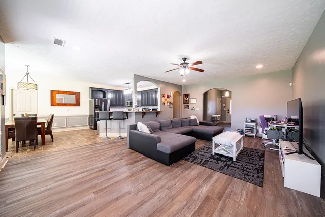 a living room with furniture and wooden floor