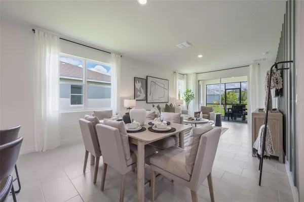 a view of a dining room with furniture and a window