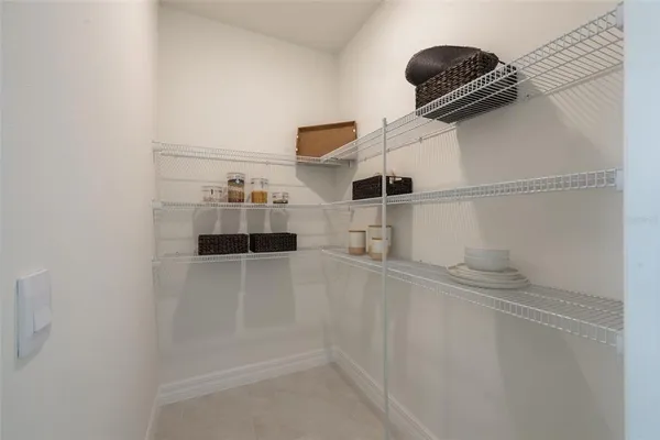 a view of storage and utility room with racks on the wall