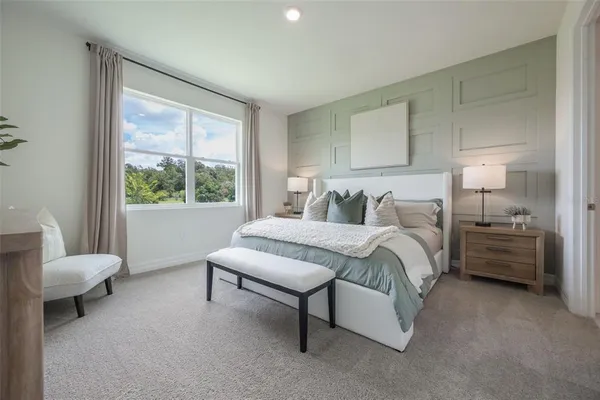 a bedroom with a bed chair and window