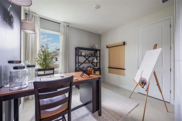a view of a dining room with furniture and a window