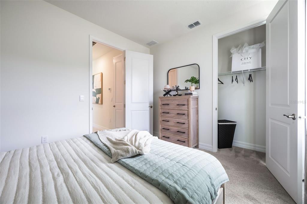 3961 Kennebunk Loop Mount Dora, FL 32757 - Photo 35 of 51 a bedroom with a bed and a dresser