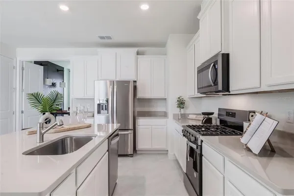 a kitchen with a sink stove and refrigerator