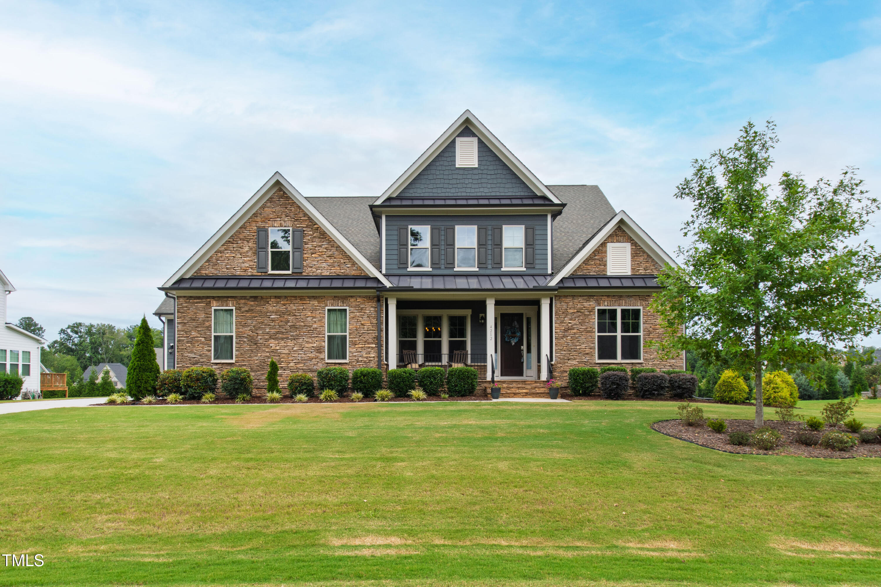 4212 Banks Stone Drive Raleigh, NC 27603 - Photo 10 of 69 a front view of a house with a garden