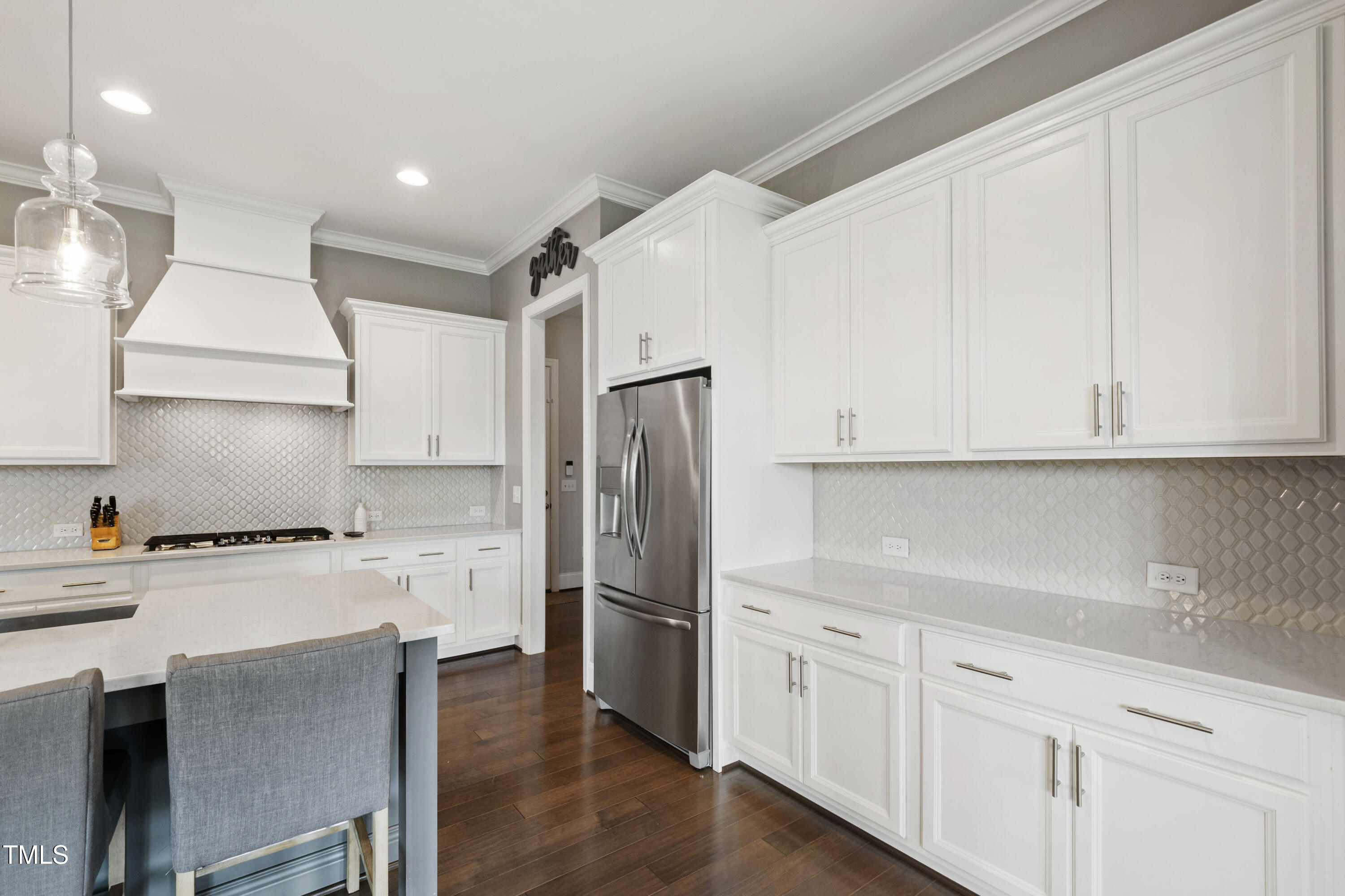 4212 Banks Stone Drive Raleigh, NC 27603 - Photo 26 of 69 a kitchen with white cabinets and stainless steel appliances