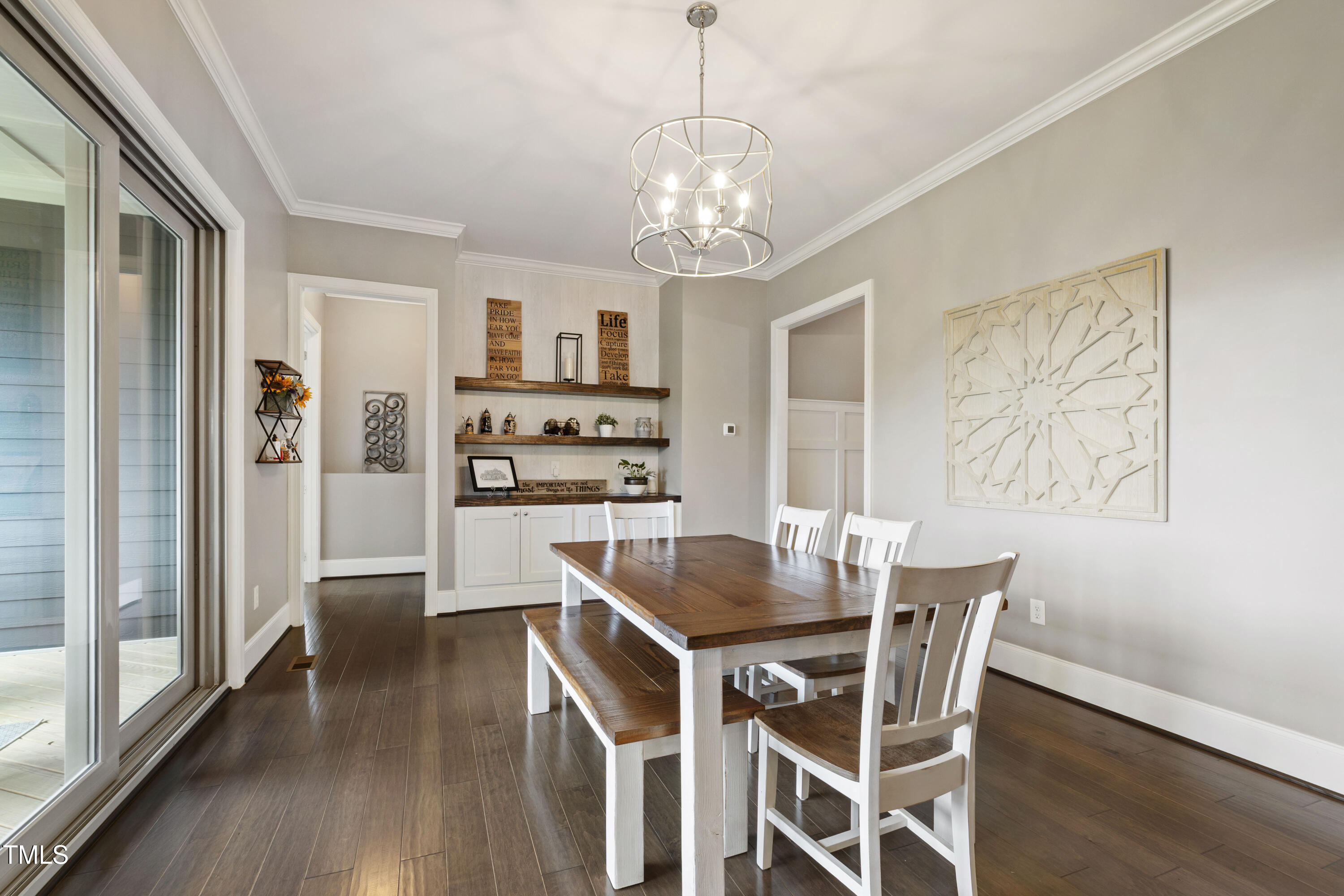 4212 Banks Stone Drive Raleigh, NC 27603 - Photo 35 of 69 a dining room with wooden floor a chandelier a wooden table and chairs