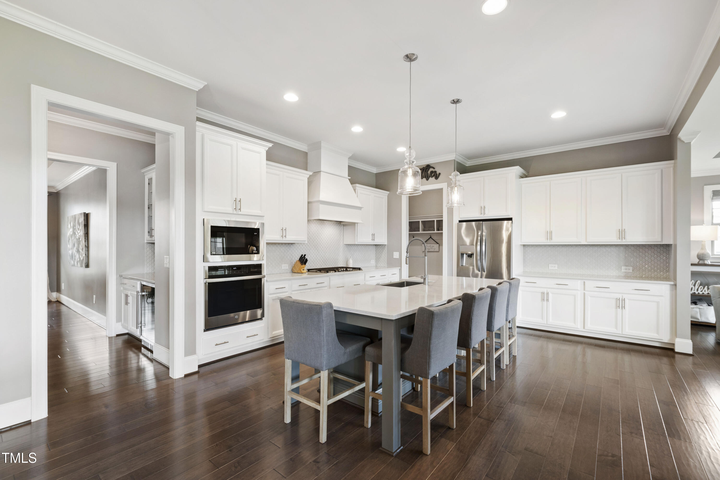 4212 Banks Stone Drive Raleigh, NC 27603 - Photo 3 of 69 a kitchen with stainless steel appliances a dining table chairs and wooden floor