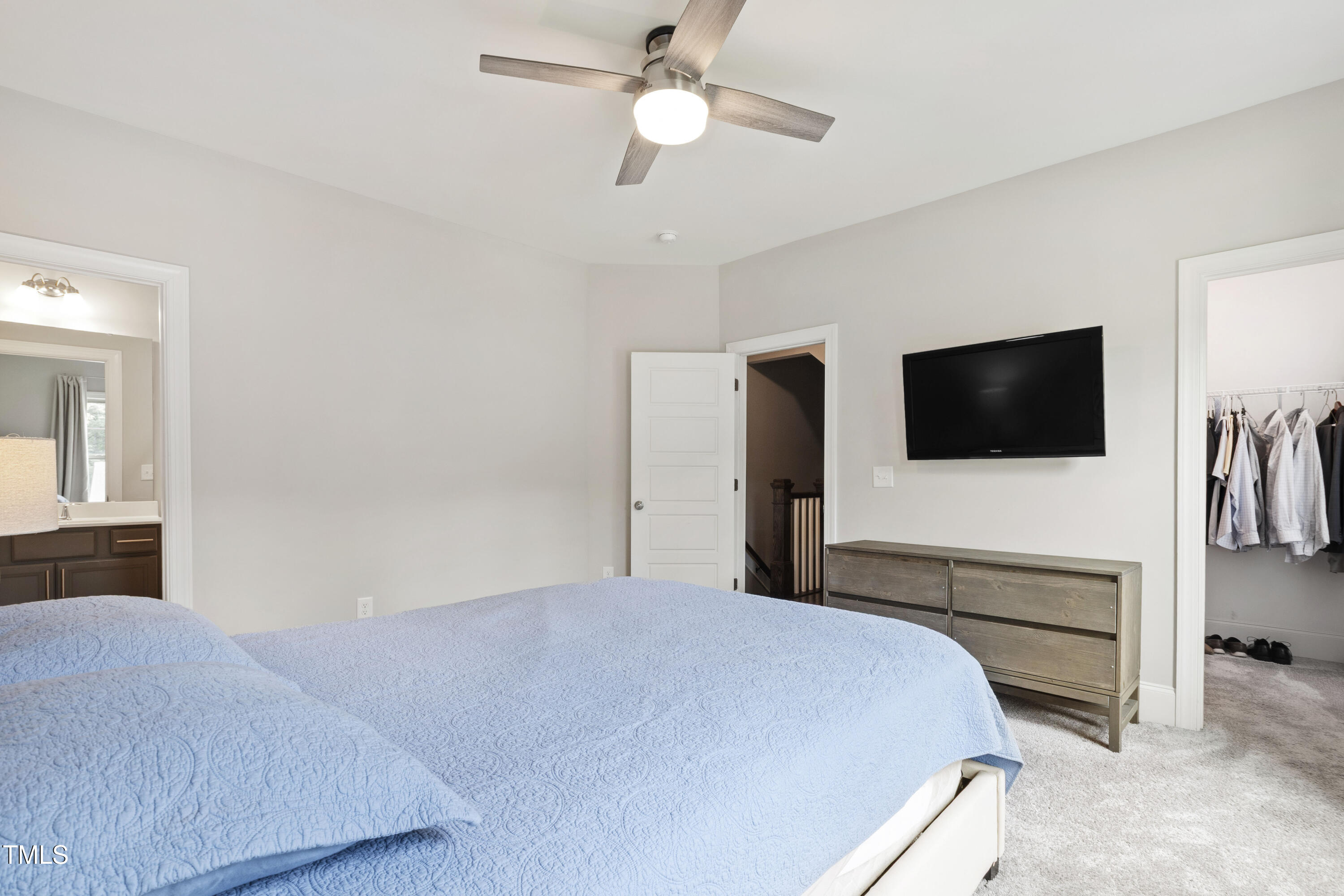 4212 Banks Stone Drive Raleigh, NC 27603 - Photo 44 of 69 a bedroom with a bed and a flat screen tv