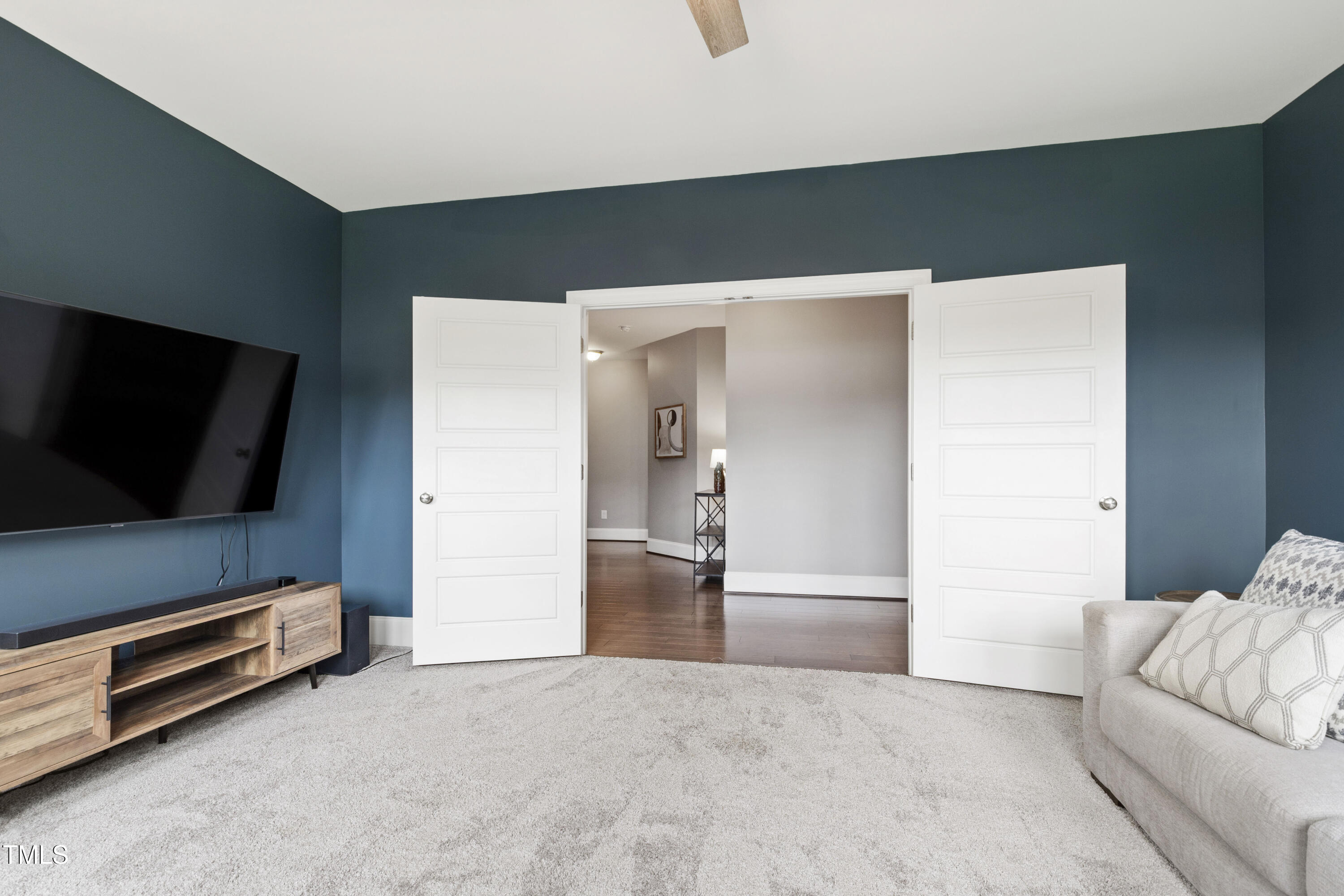 4212 Banks Stone Drive Raleigh, NC 27603 - Photo 49 of 69 a living room with furniture and a flat screen tv