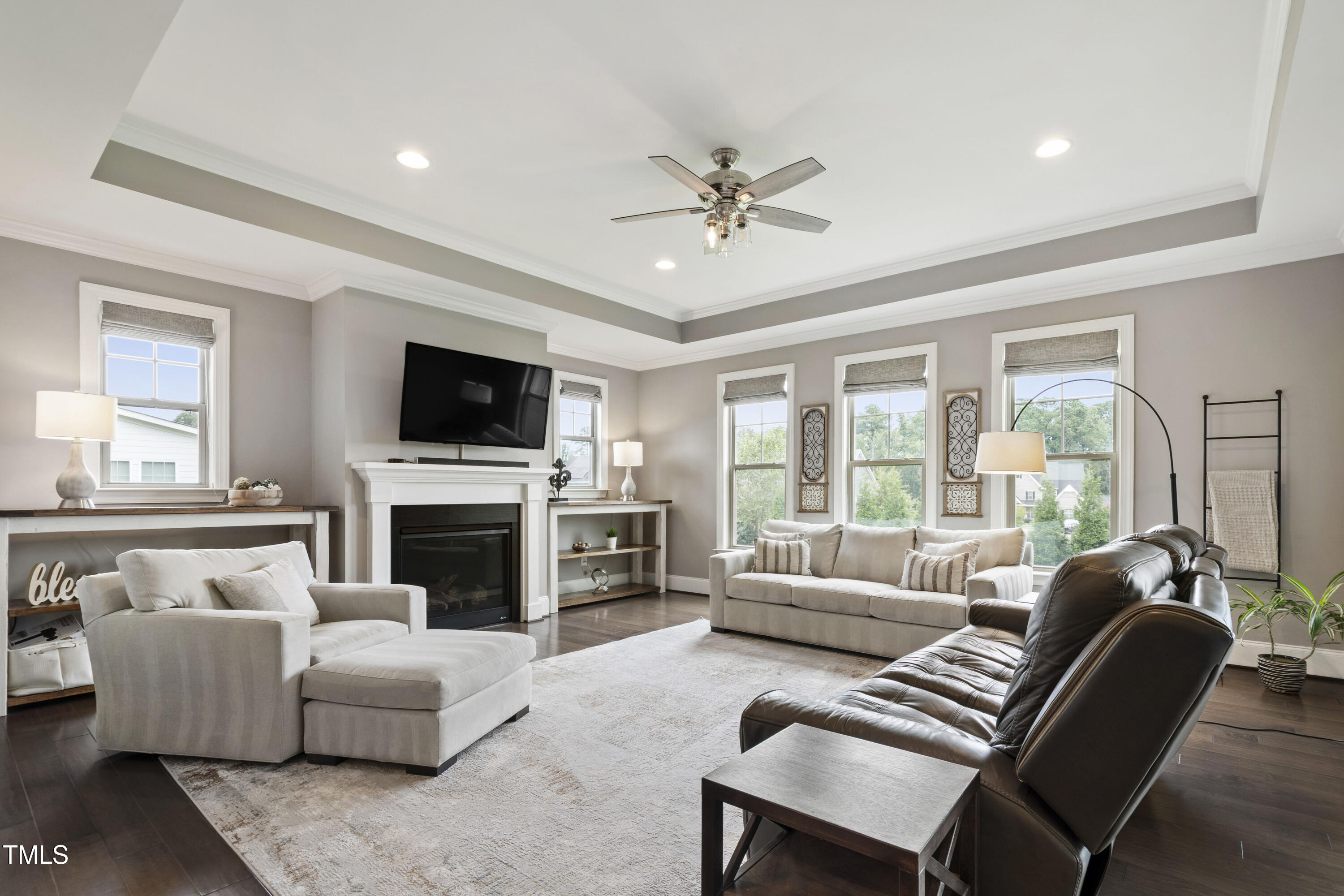 4212 Banks Stone Drive Raleigh, NC 27603 - Photo 4 of 69 a living room with furniture a flat screen tv and a fireplace