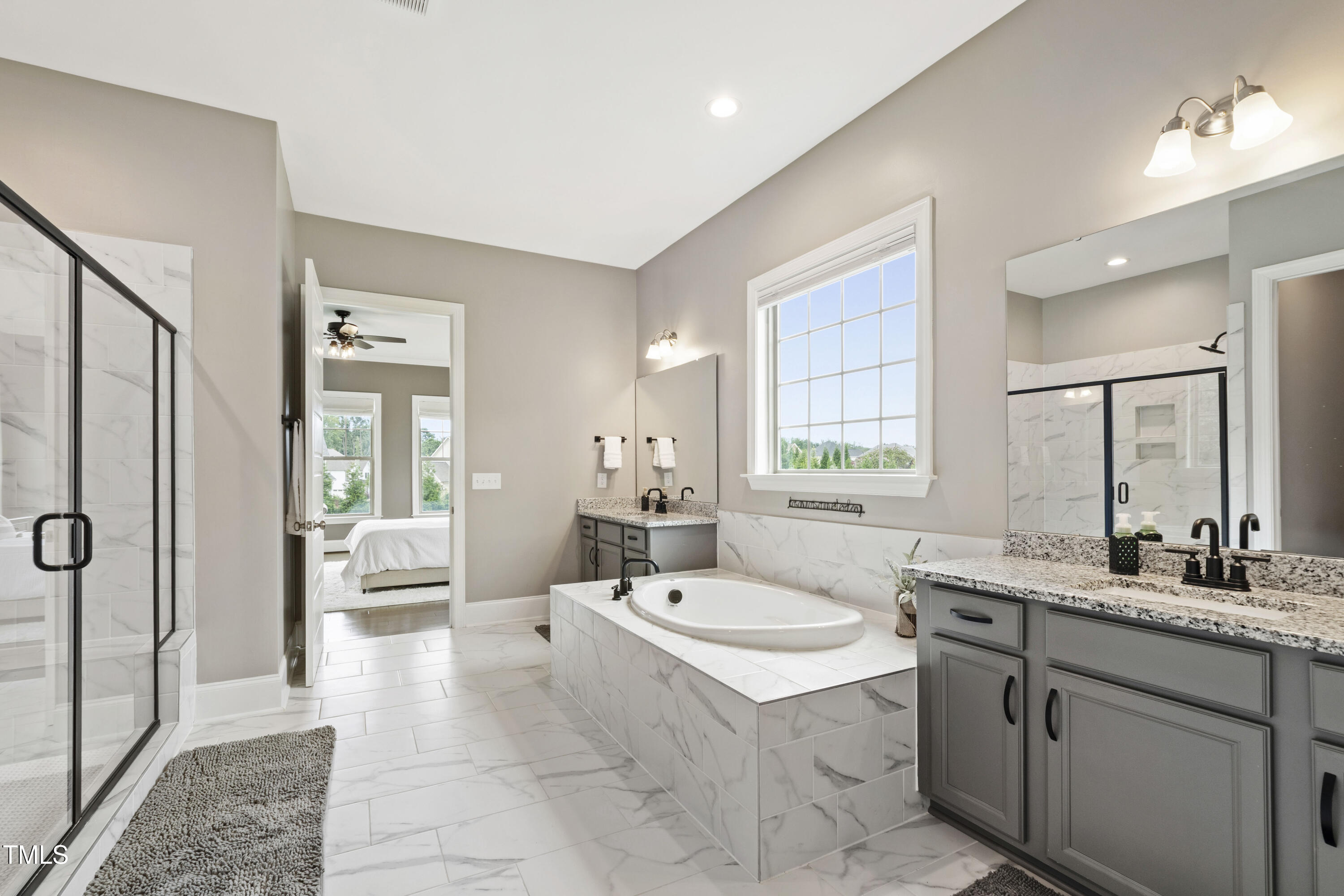 4212 Banks Stone Drive Raleigh, NC 27603 - Photo 6 of 69 a bathroom with a sink double vanity granite tub shower and mirror