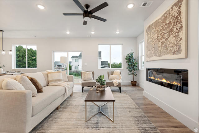 529 North Hvn Drive Mapleton, UT 84664 - Photo 5 of 30 Spacious living area featuring a linear electric fireplace, wood-finish flooring, recessed lighting, and a modern ceiling fan