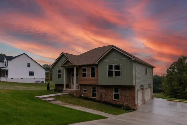 a large kitchen with stainless steel appliances kitchen island a large counter top a sink and a refrigerator