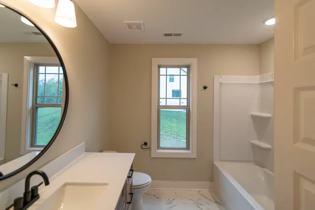 a view of a lake with houses in the back