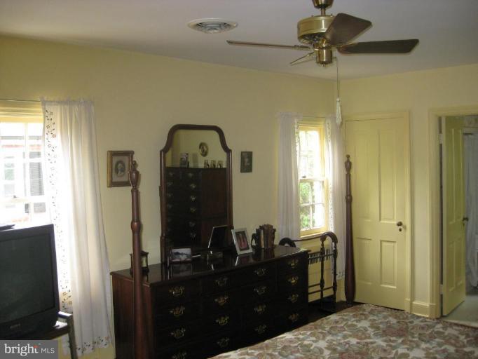 5706 Kenmore Road Baltimore, MD 21210 - Photo 8 of 18 a bedroom with a bed and a mirror on dresser