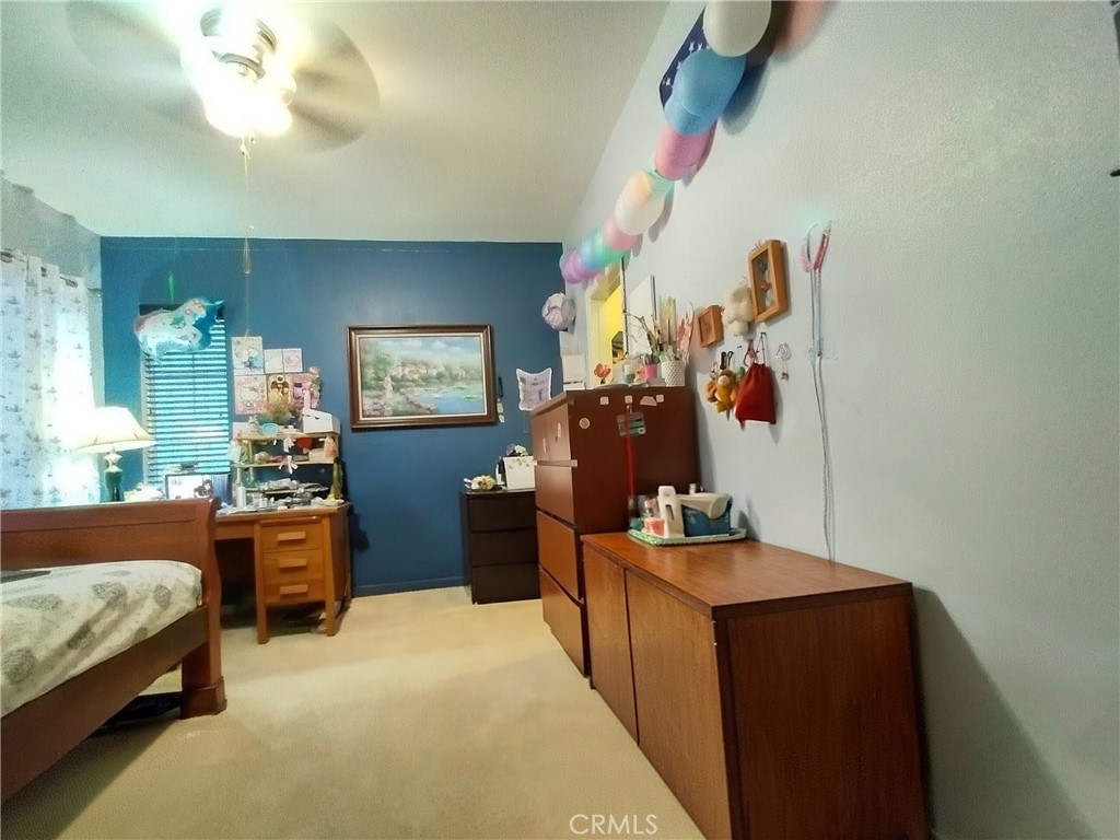 11811 Cramer Road Yucaipa, CA 92399 - Photo 38 of 56 a bedroom with bed and a chandelier