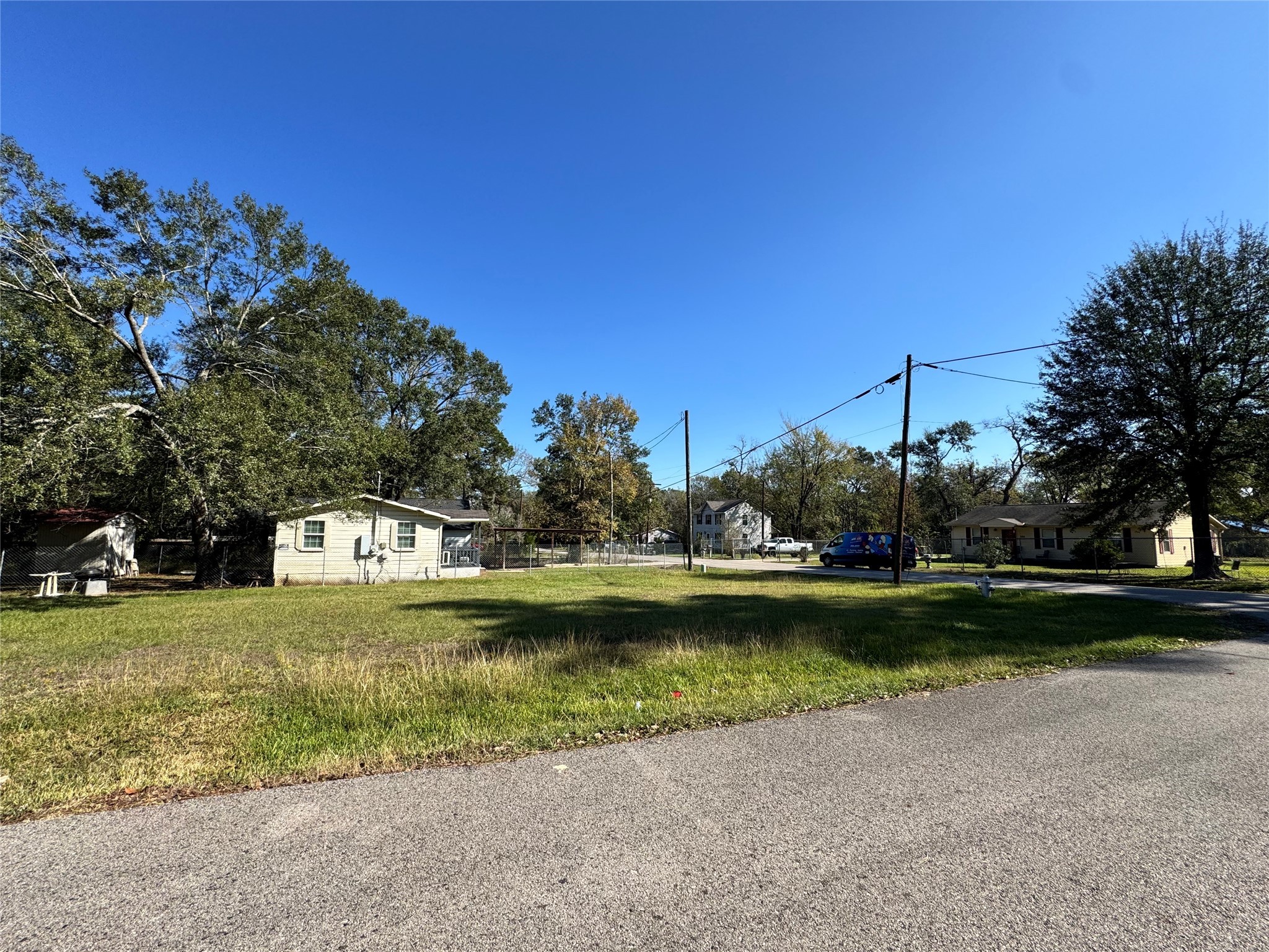700 College Street Conroe, TX 77301 - Photo 2 of 8 a view of a lake with houses in background
