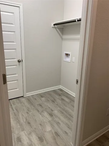 an empty room with a wooden closet