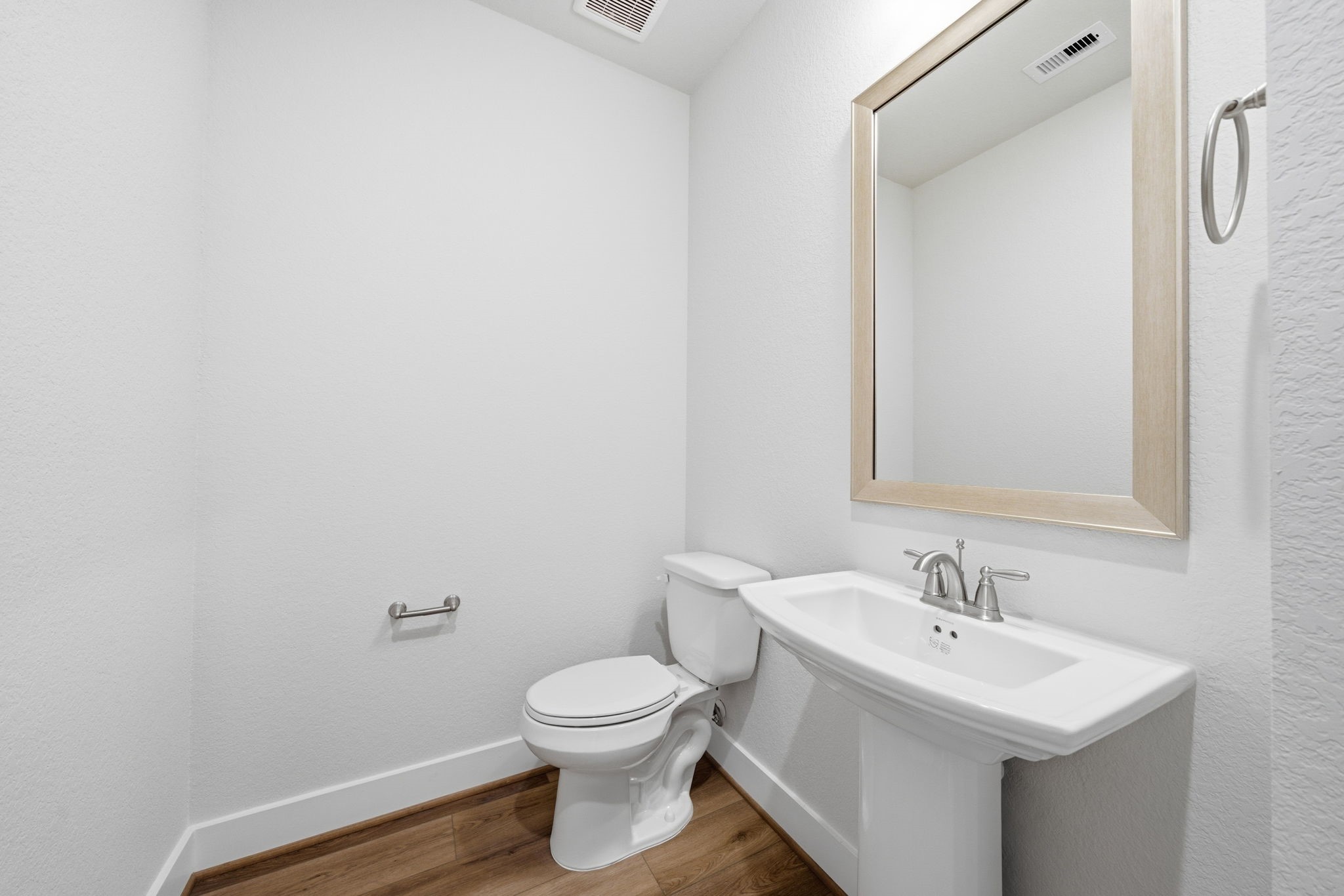 10026 Larkin Cove Willis, TX 77318 - Photo 29 of 46 a bathroom with a toilet sink and mirror