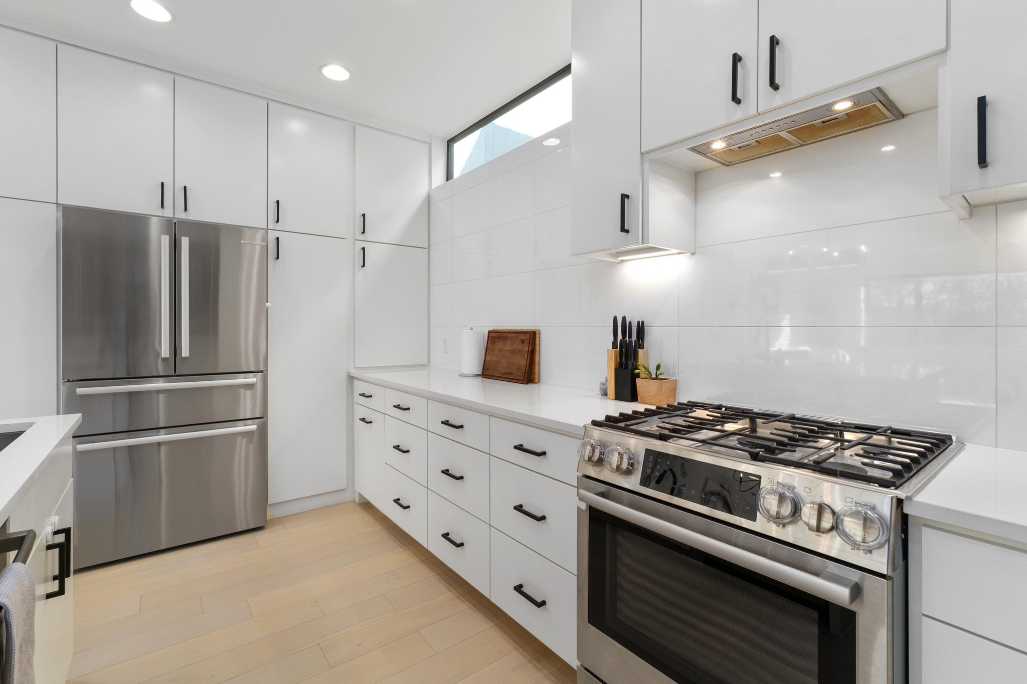 3406 East 17th Street, Unit 4 Austin, TX 78721 - Photo 11 of 32 a kitchen with stainless steel appliances granite countertop a stove and a refrigerator