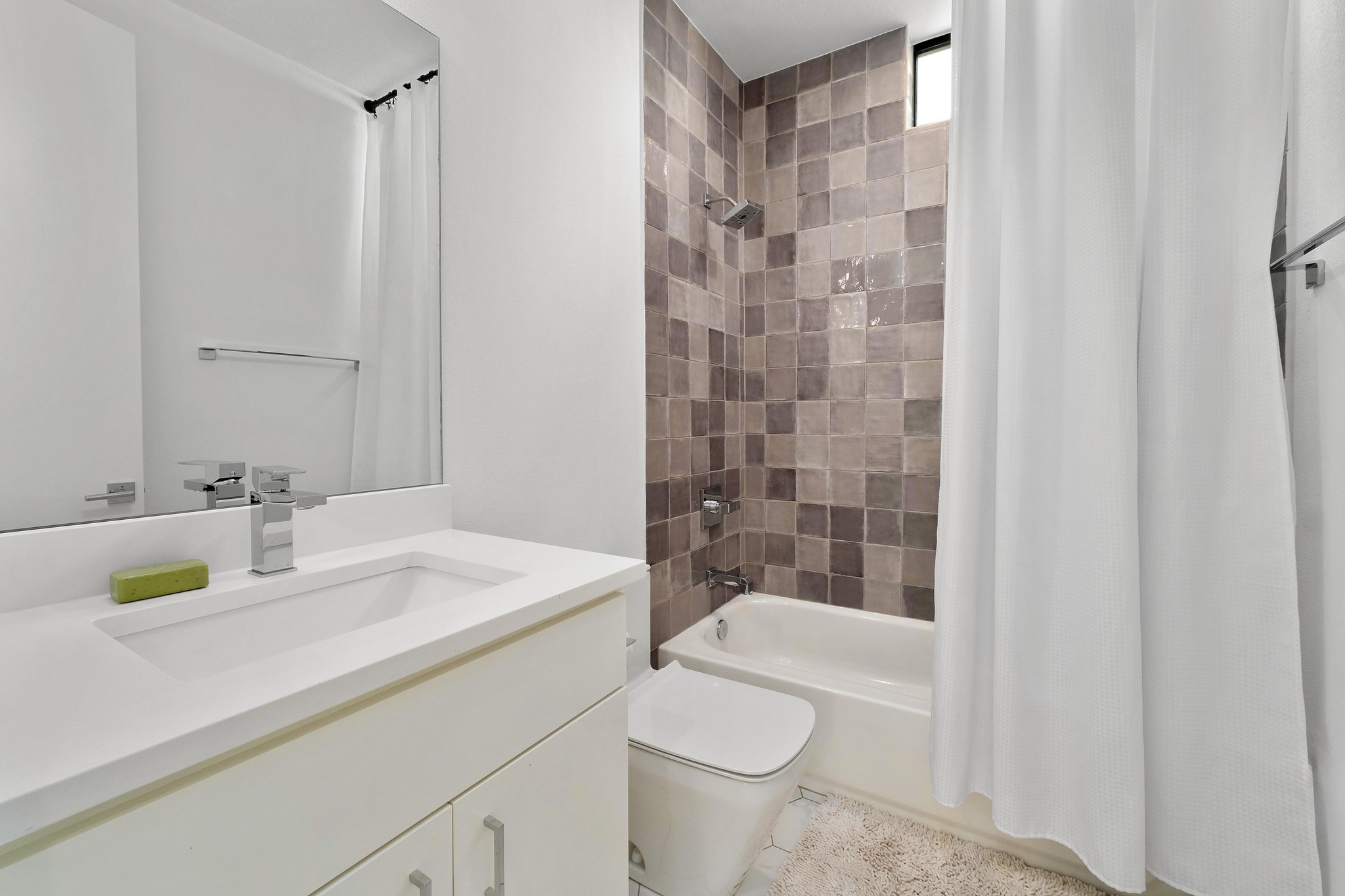 3406 East 17th Street, Unit 4 Austin, TX 78721 - Photo 17 of 32 a bathroom with a sink a toilet and shower