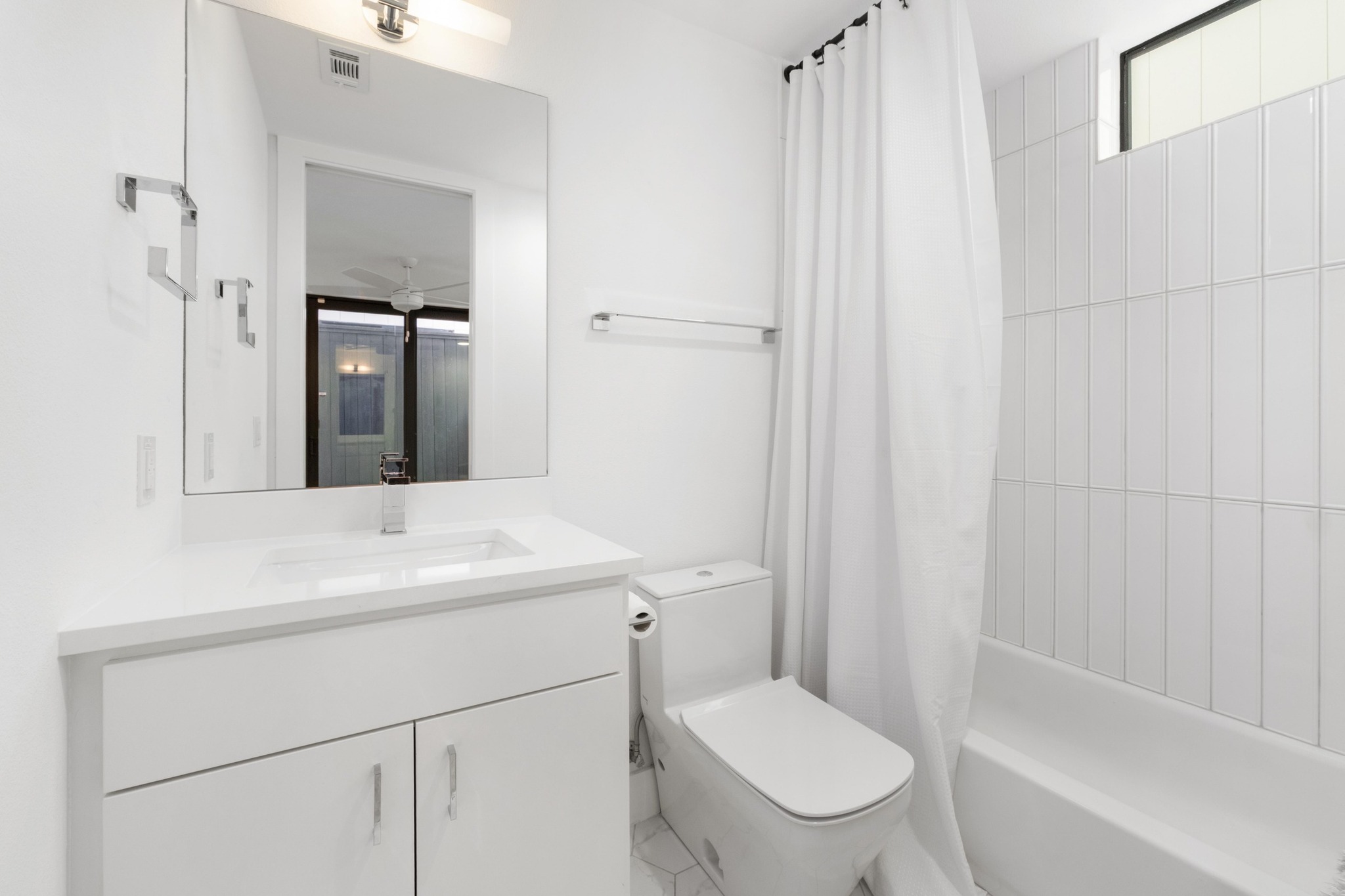 3406 East 17th Street, Unit 4 Austin, TX 78721 - Photo 23 of 32 a bathroom with a sink toilet vanity and shower