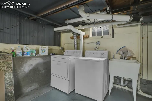 a utility room with cabinets washer and dryer