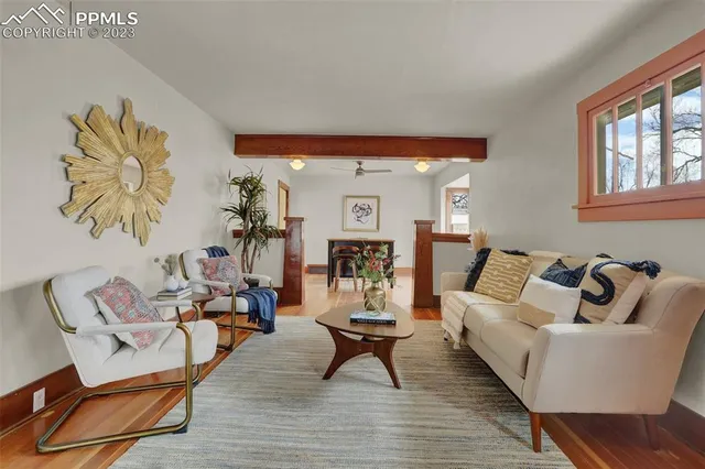 a living room with furniture and wooden floor