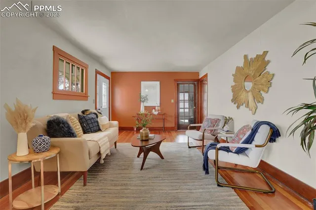 a living room with furniture and wooden floor