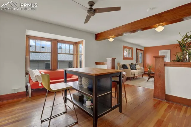 a living room with furniture a fireplace and wooden floor