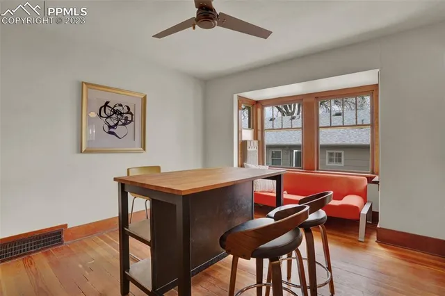 a view of a dining room with furniture window and wooden floor