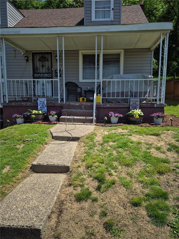a view of a house with a yard and sitting area