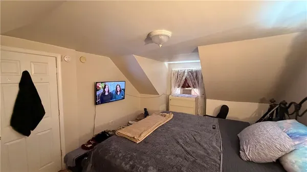 a bedroom with a bed and flat screen tv