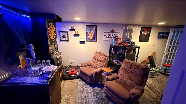 a living room with furniture a projector and bookshelf