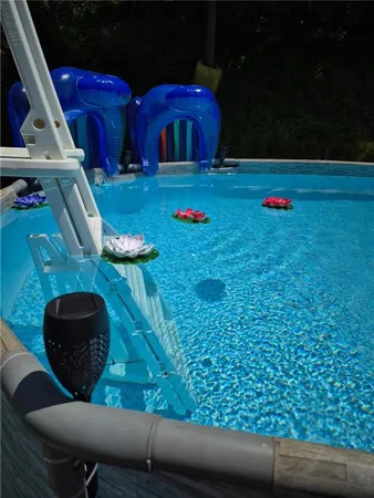 a swimming pool with outdoor seating and yard
